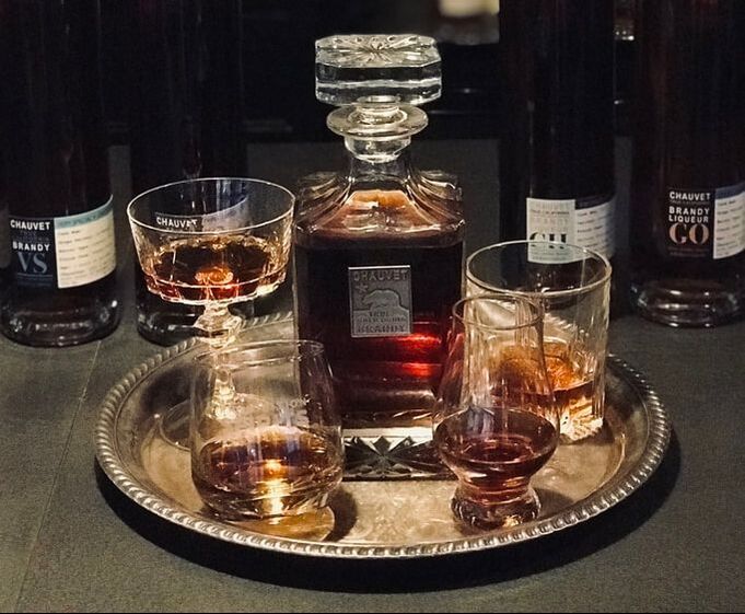 XOX Reserve Brandy on tray with various glasses
