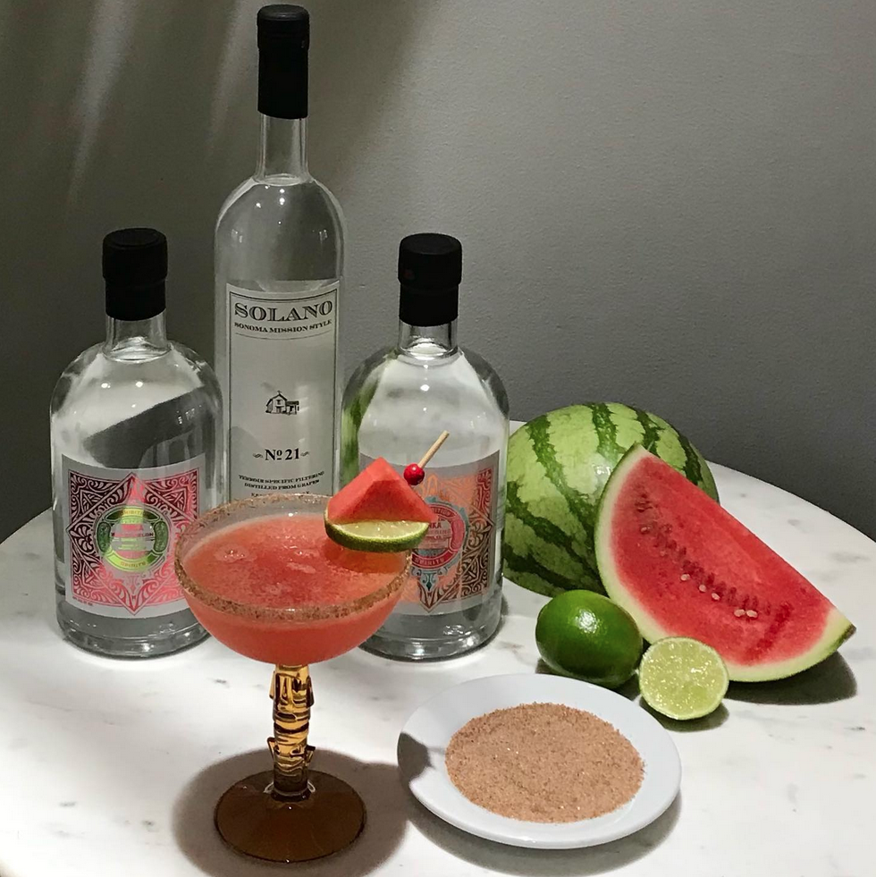 Watermelon punch cocktail with fresh watermelon and vodka bottles
